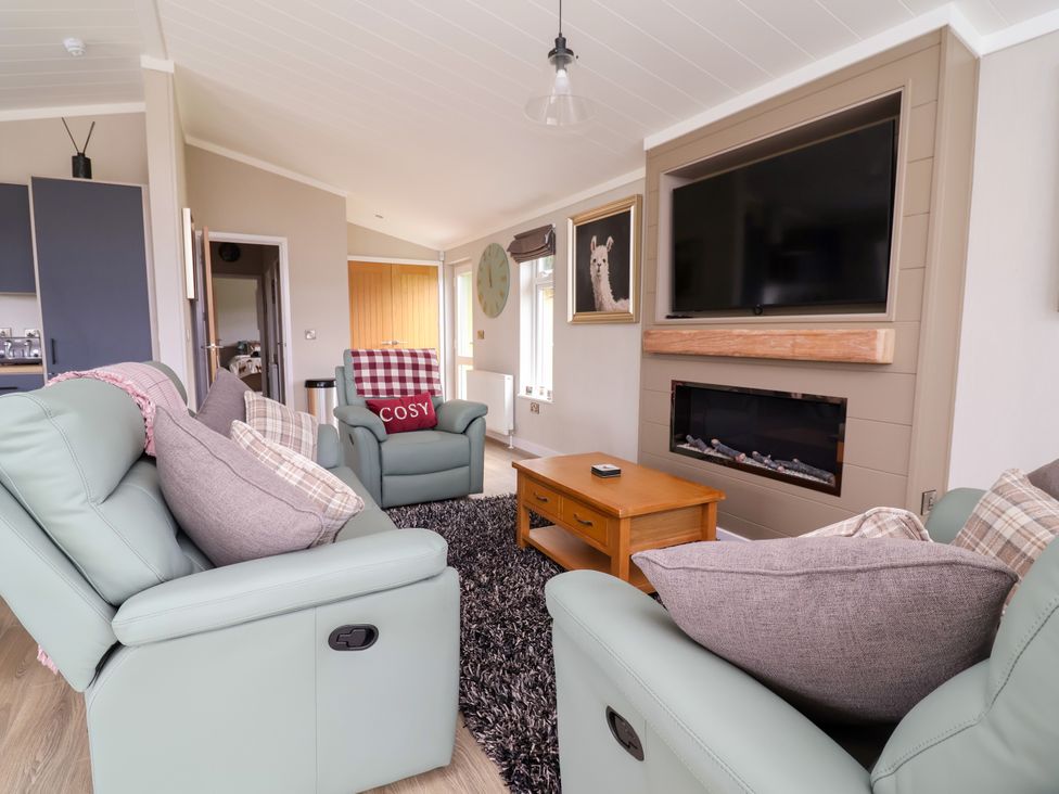 A living room with sofas and a television at Beach Lodge in Lloc