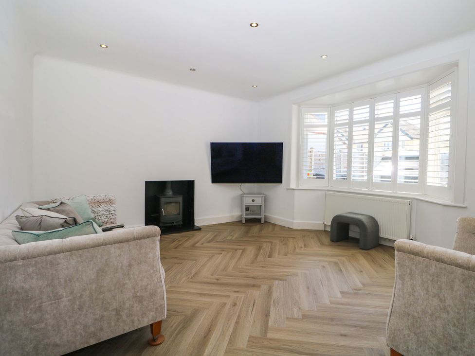A living room with a television and fireplace at Shoreline Retreat Bournemouth