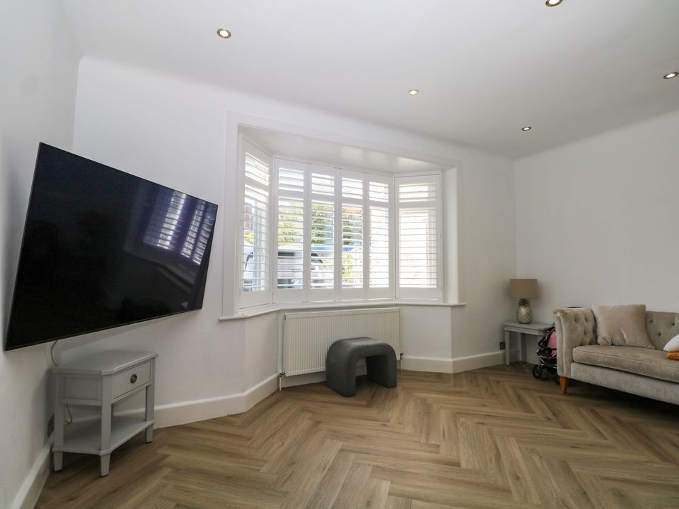 A living room with a television and a sofa at Shoreline Retreat in Bournemouth