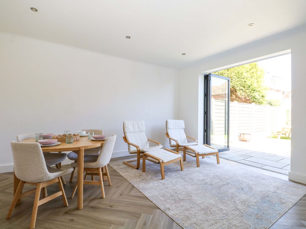 A dining room with a table and chairs at Shoreline Retreat in Bournemouth