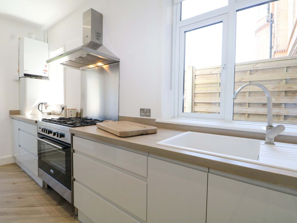 A kitchen with a cooker and sink at Shoreline Retreat in Bournemouth
