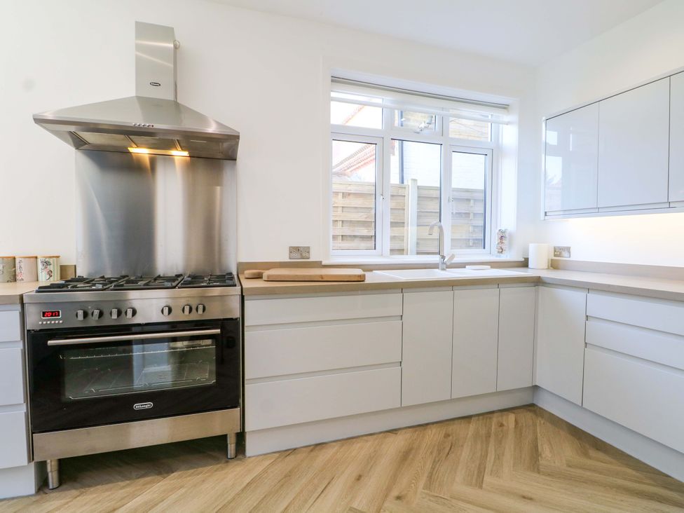 A kitchen with a cooking range and sink at Shoreline Retreat in Bournemouth
