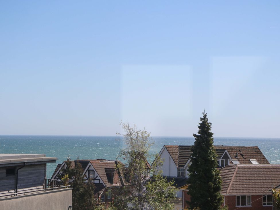 A view of the sea with houses and trees at Shoreline Retreat, Bournemouth
