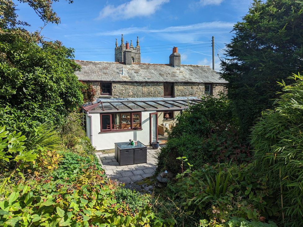 A cottage with a conservatory and patio area at Trehaverock Cottage St. Endellion near Port Isaac