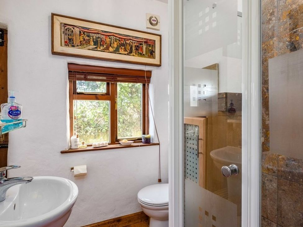 A bathroom with a sink, shower, and toilet at Trehaverock Cottage in St. Endellion near Port Isaac