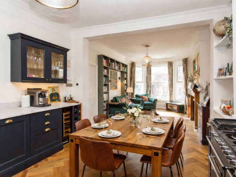 A dining area with a table set for dinner at 19 East Cliff Gardens in Folkestone