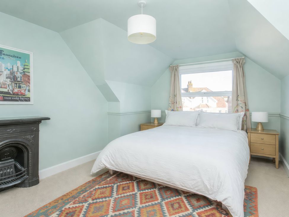 A bedroom with a bed and bedside tables at 19 East Cliff Gardens in Folkestone