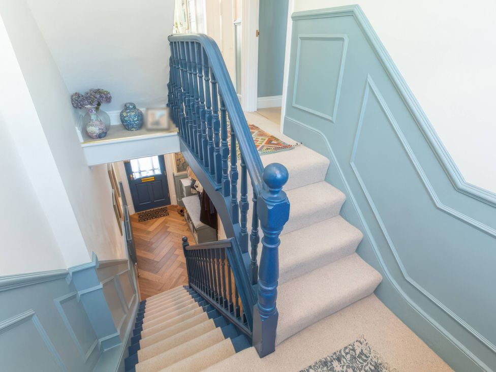 A staircase and decorative items in a hallway at 19 East Cliff Gardens in Folkestone