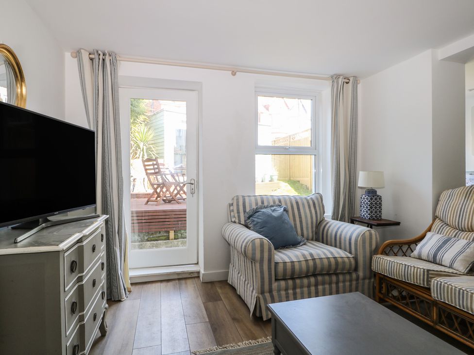 A living room with a sofa and television at East Cliff Gardens in Folkestone