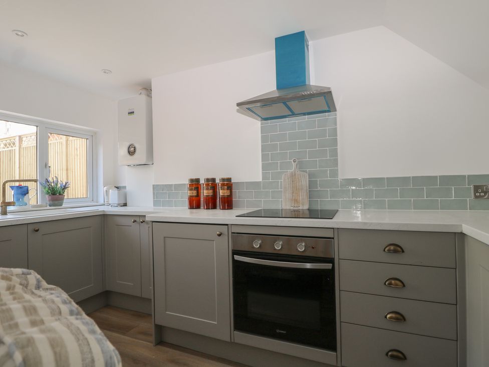 A kitchen with cabinets and stove at East Cliff Gardens in Folkestone