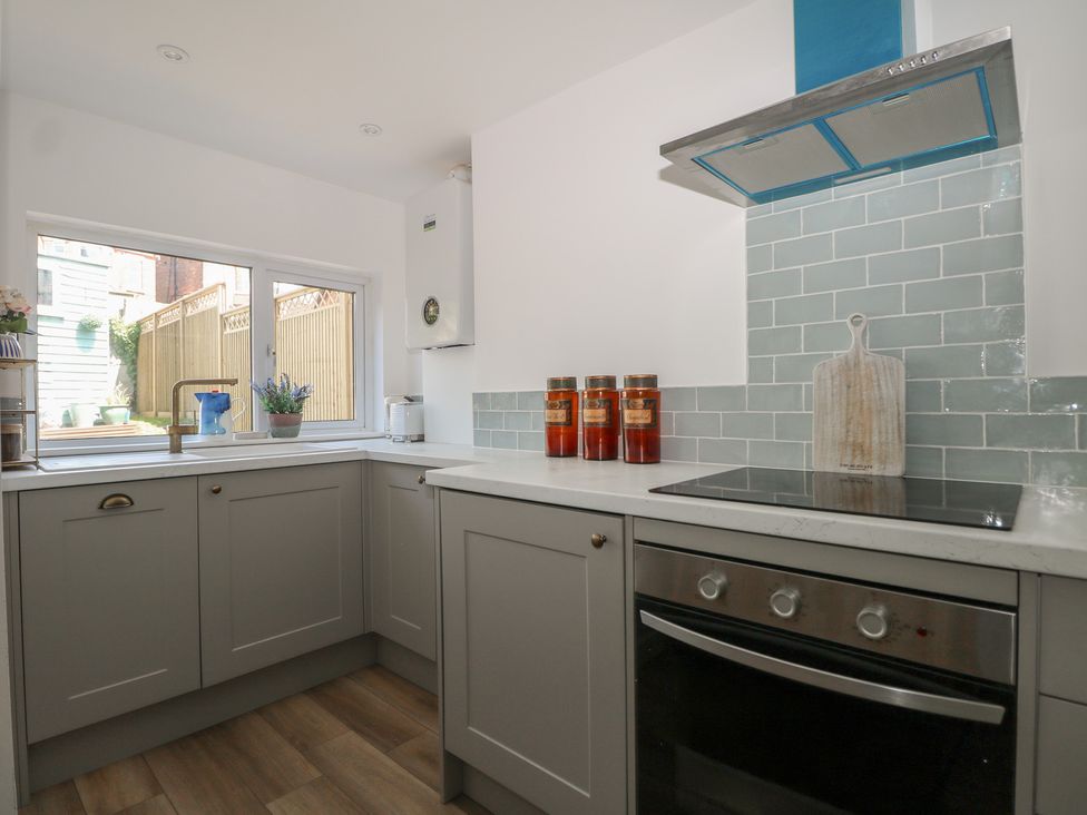 A kitchen with a window and stove at East Cliff Gardens in Folkestone