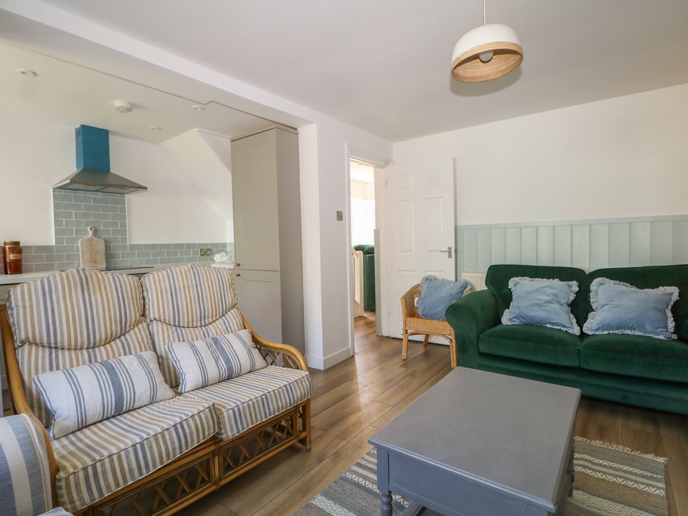 A living room with a sofa and coffee table at East Cliff Gardens in Folkestone