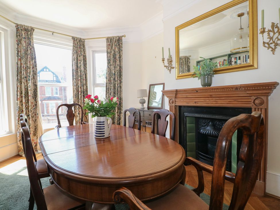 A dining room with a table and chairs at East Cliff Gardens in Folkestone