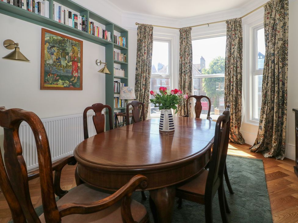 A dining room with a table and chairs at East Cliff Gardens, Folkestone