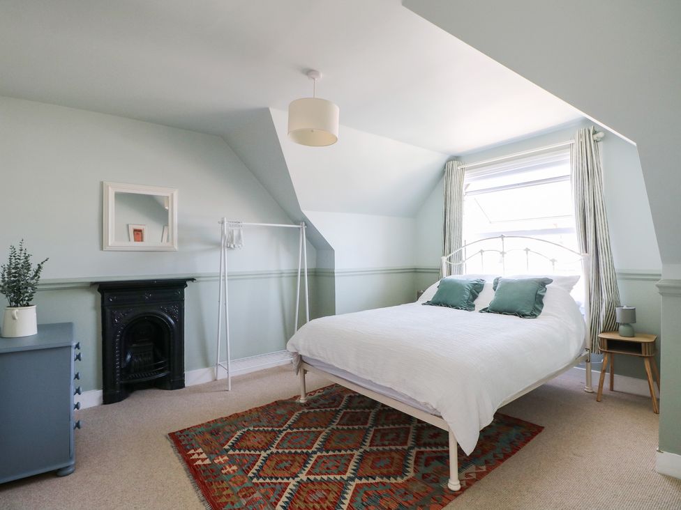 A bedroom with a bed and furniture at East Cliff Gardens in Folkestone