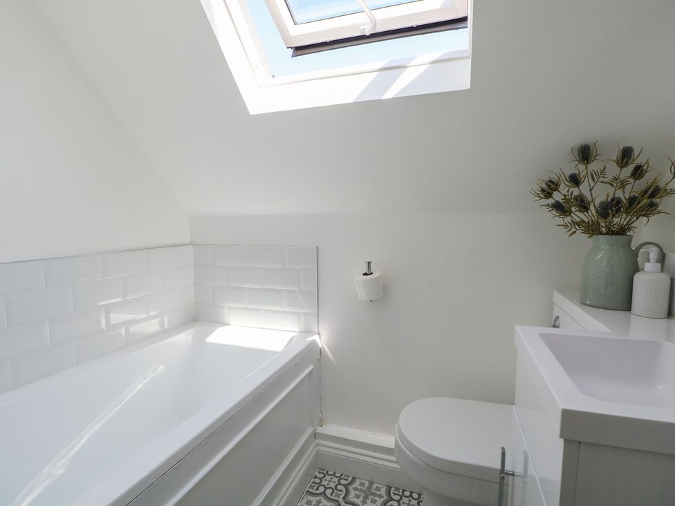 A bathroom with a bathtub, toilet, and sink at East Cliff Gardens in Folkestone