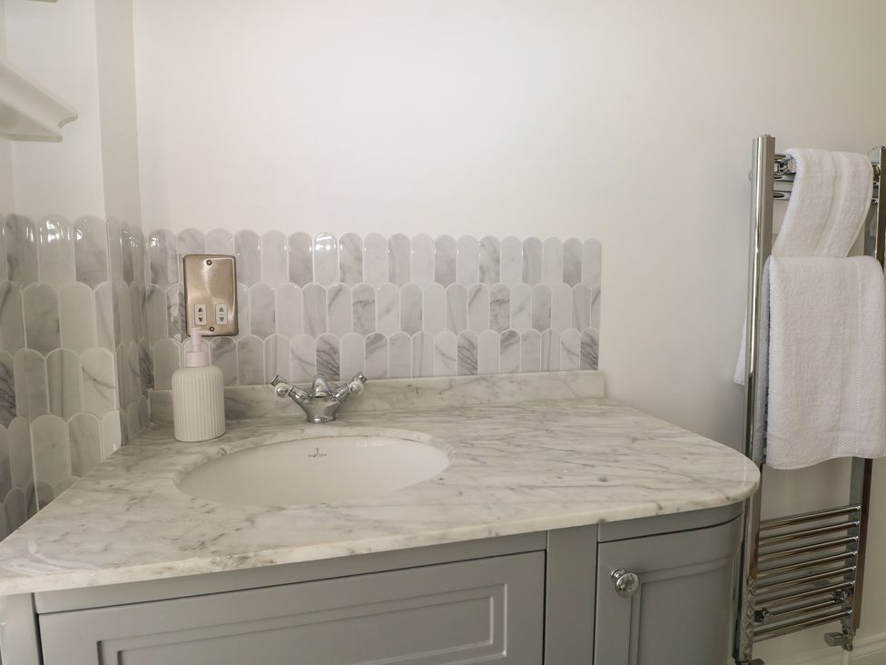 A bathroom with a sink and faucet at East Cliff Gardens in Folkestone