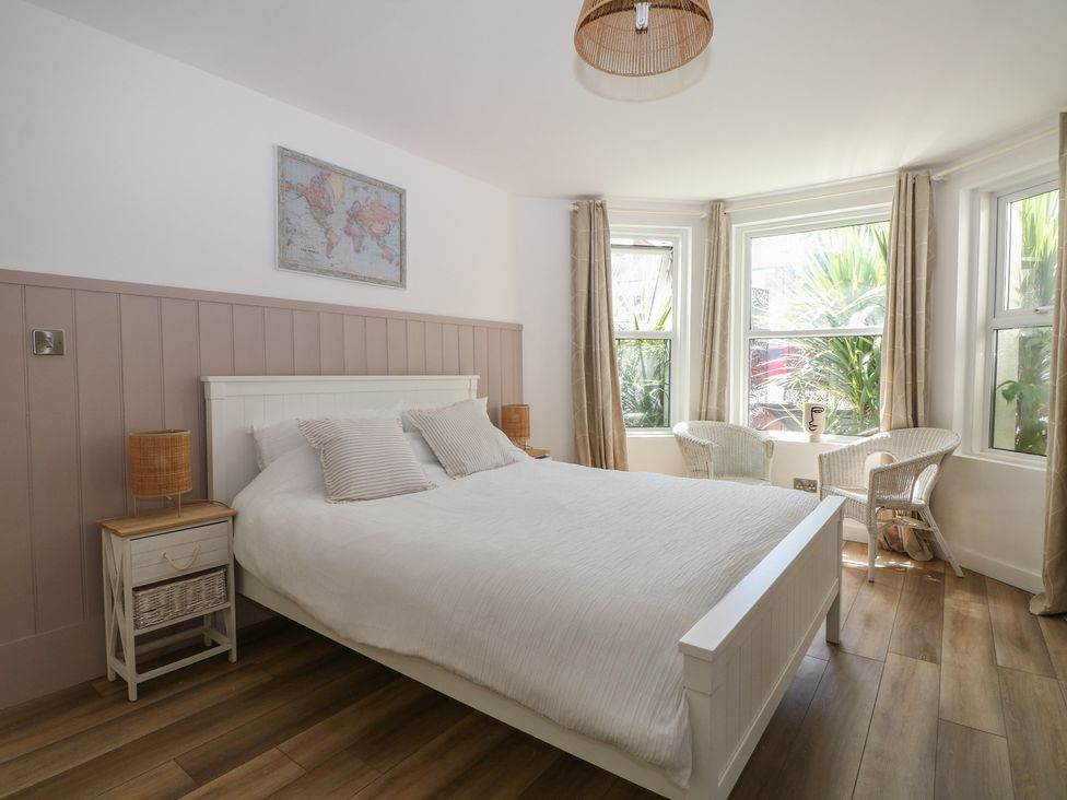A bedroom with a bed and seating area at East Cliff Gardens in Folkestone