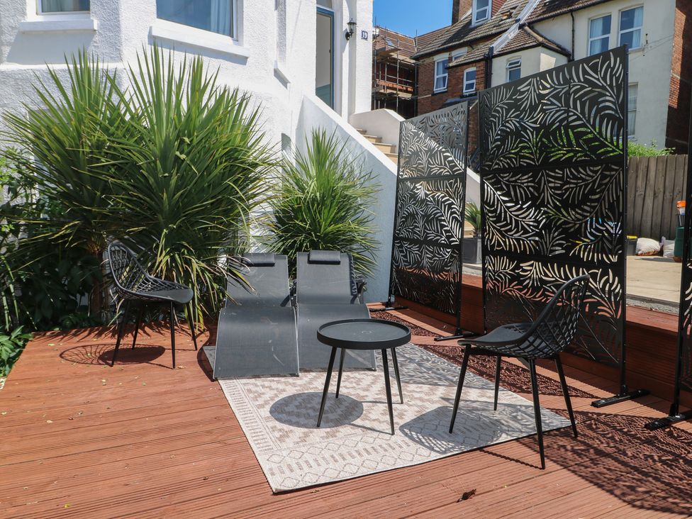 A seating area with plants and furniture at East Cliff Gardens in Folkestone