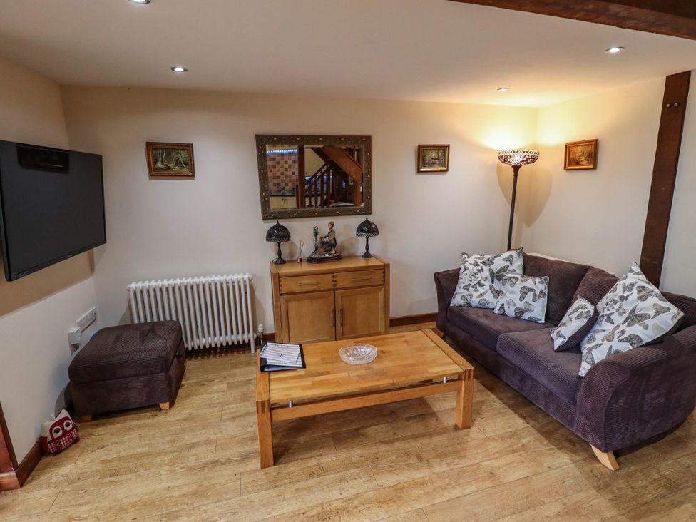 A living room with a sofa and coffee table at Willow Tree Barn in Spalding