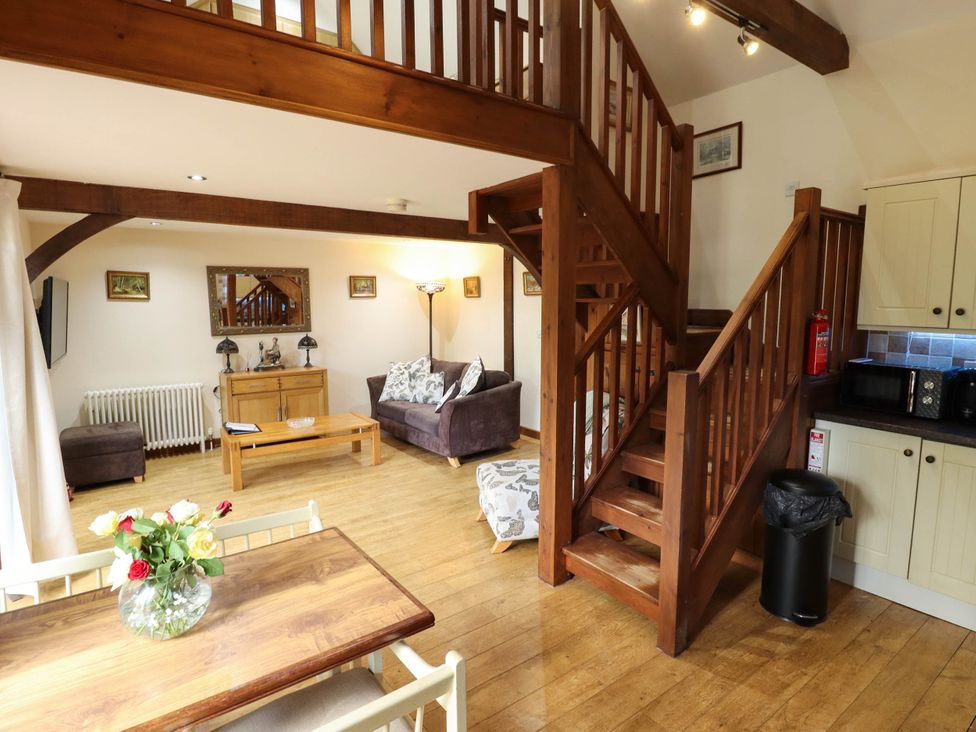 A living room with a staircase and furniture at Willow Tree Barn in Spalding