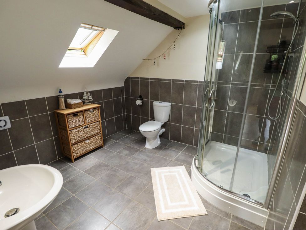 A bathroom with a shower and basin at Willow Tree Barn in Spalding