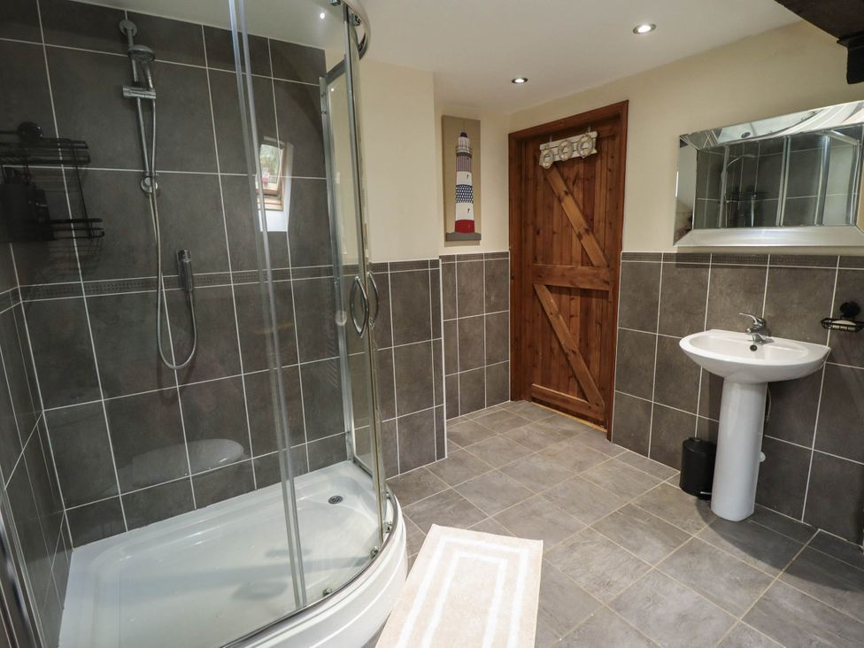 A bathroom with a shower and sink at Willow Tree Barn in Spalding