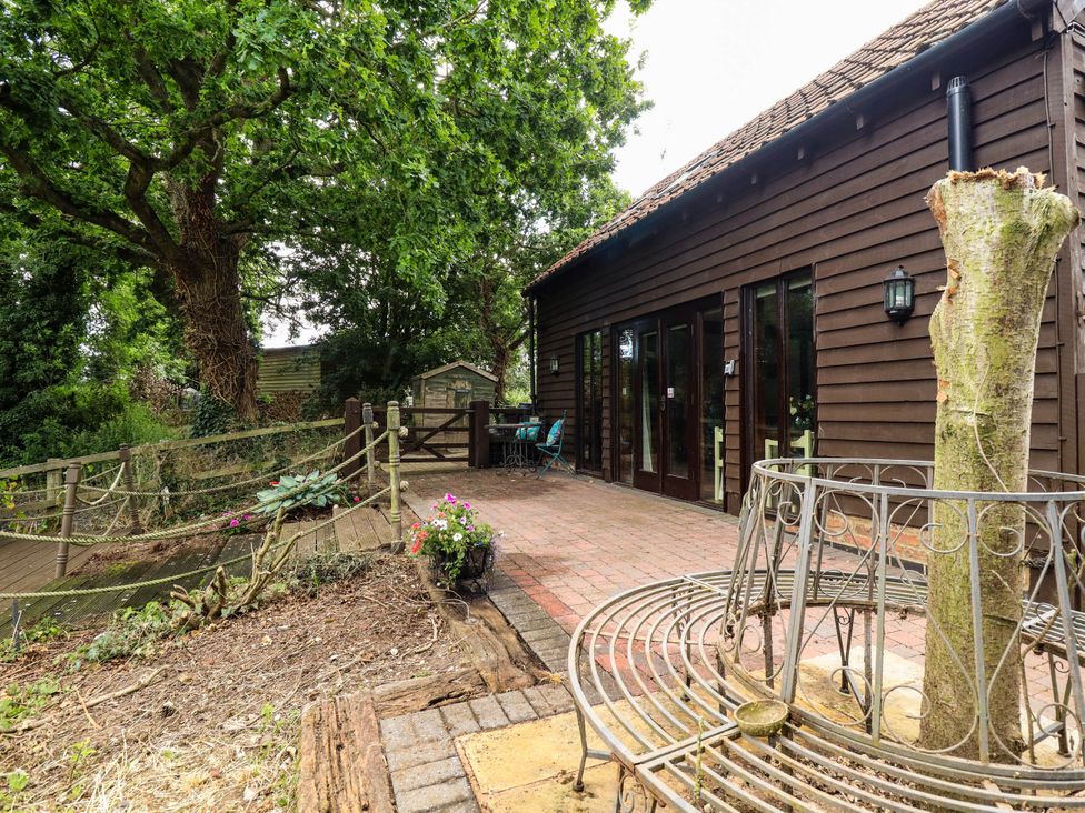 An outdoor area with a tree and seating at Willow Tree Barn in Spalding