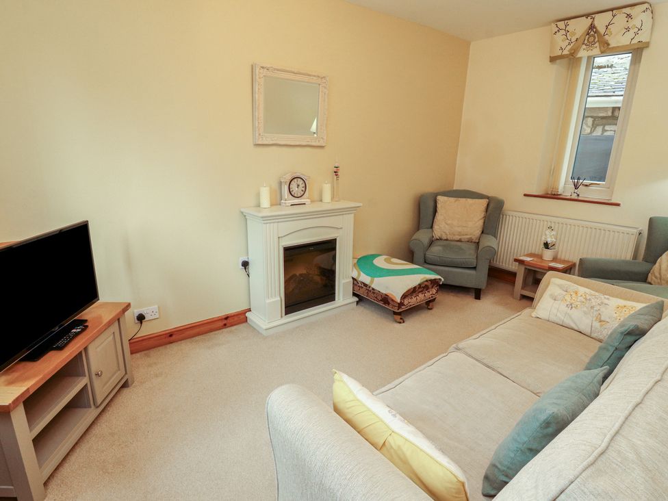 A living room with a television and sofa at The Haven in Heysham