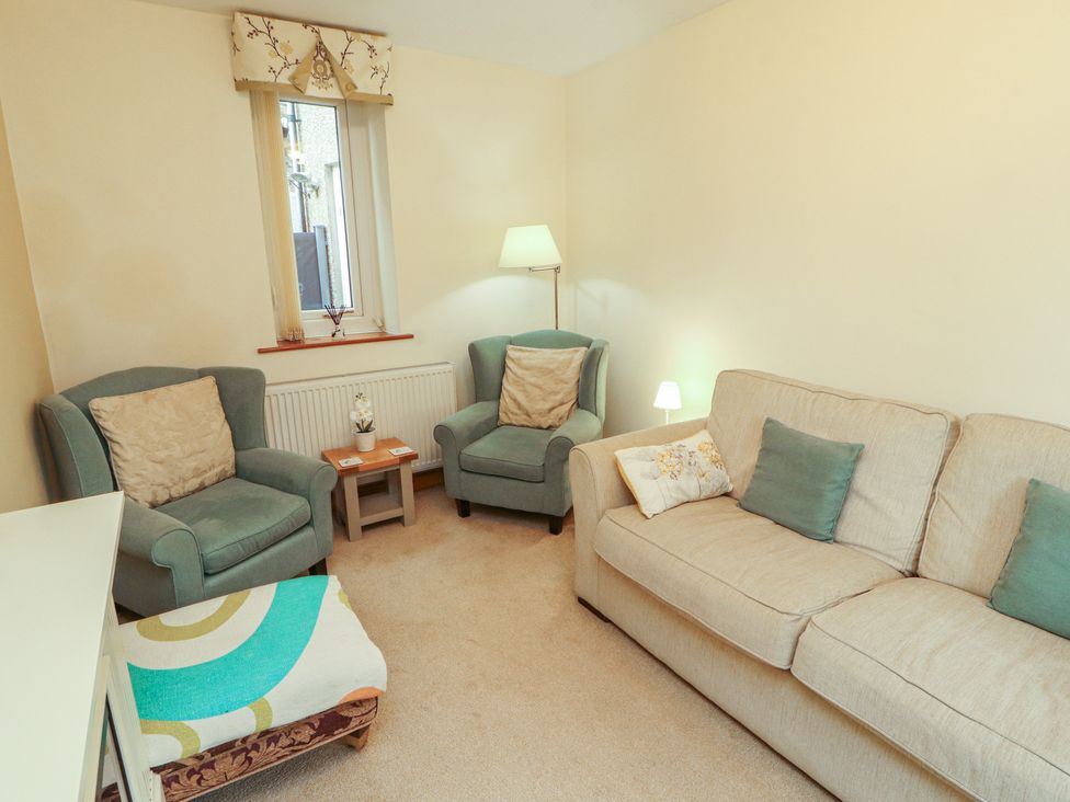 A living room with armchairs and a sofa at The Haven in Heysham