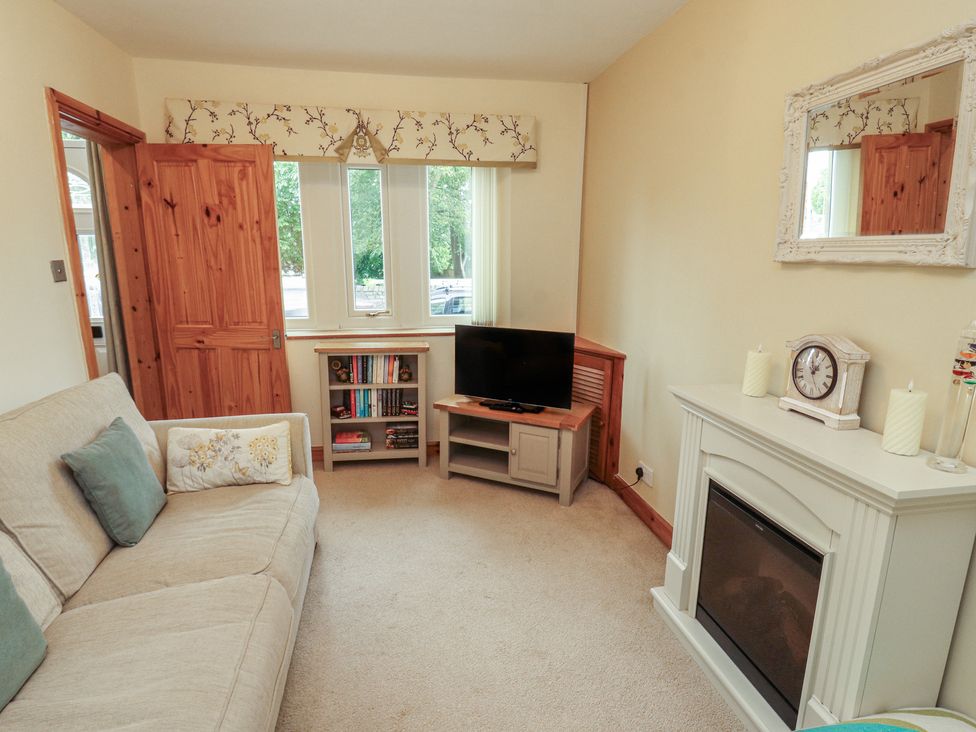 A living room with a sofa and television at The Haven in Heysham