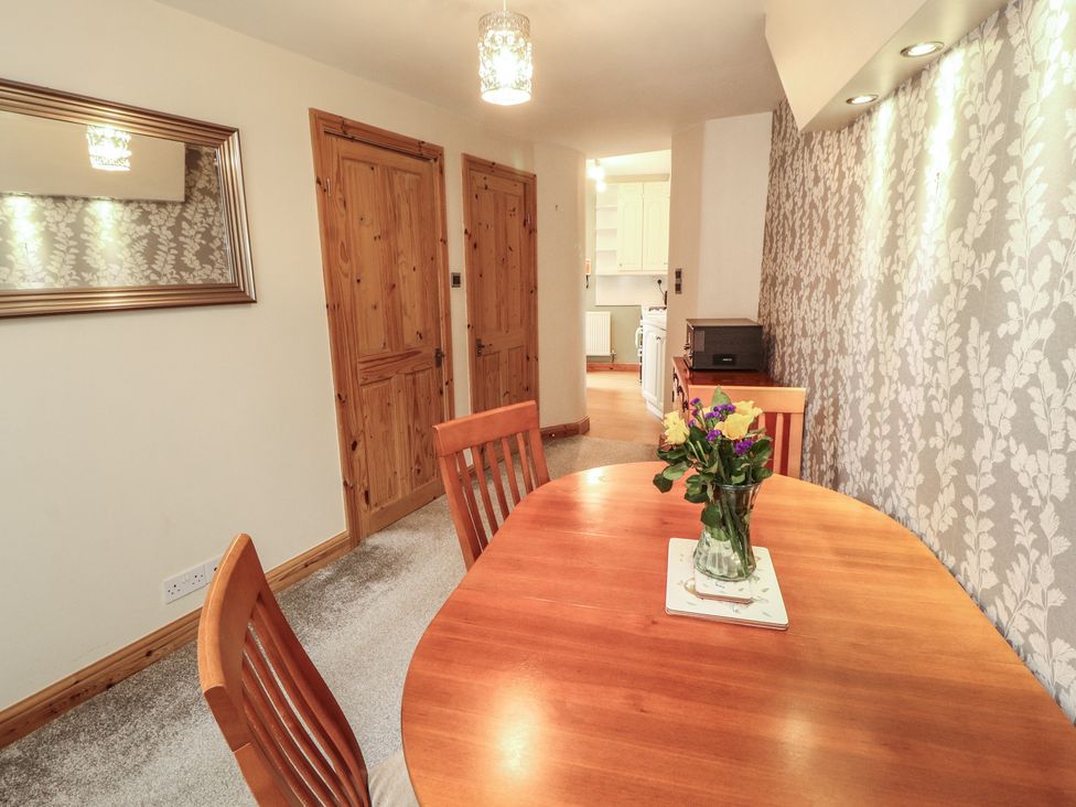 A dining room with a table and chairs at The Haven in Heysham