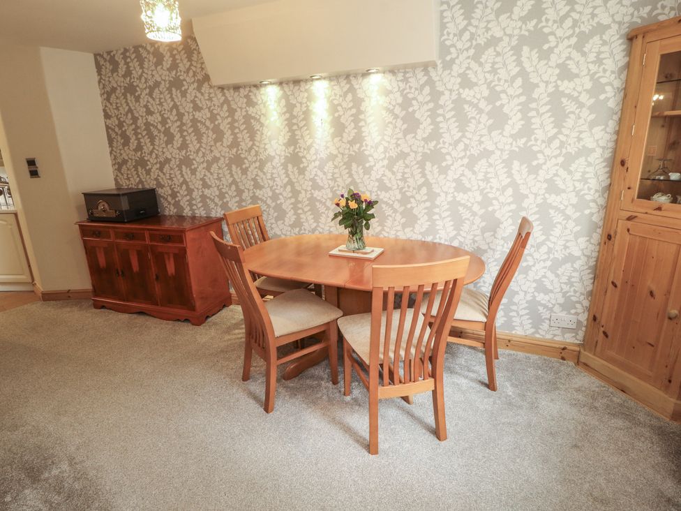 A dining room with a table and chairs at The Haven in Heysham