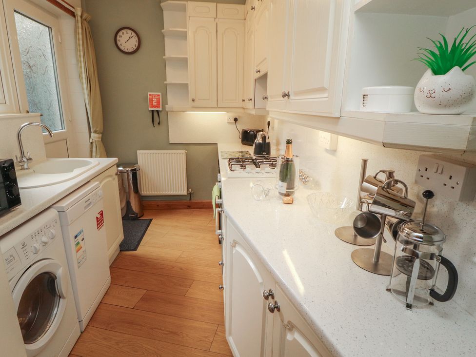 A kitchen with appliances and kitchenware at The Haven in Heysham