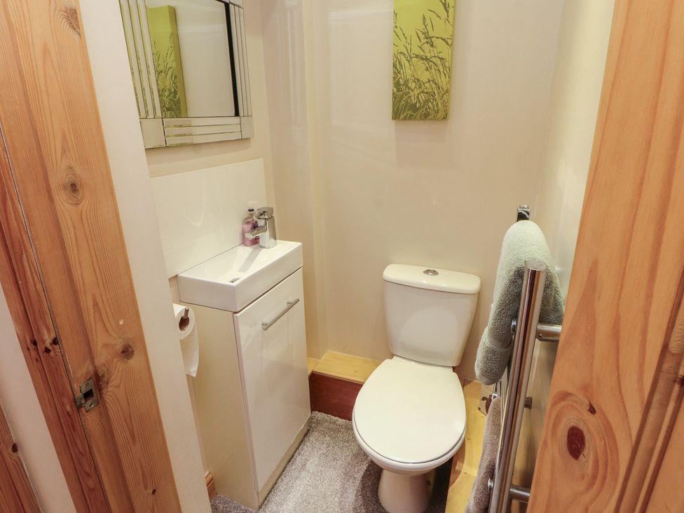 A bathroom with a toilet and sink at The Haven in Heysham