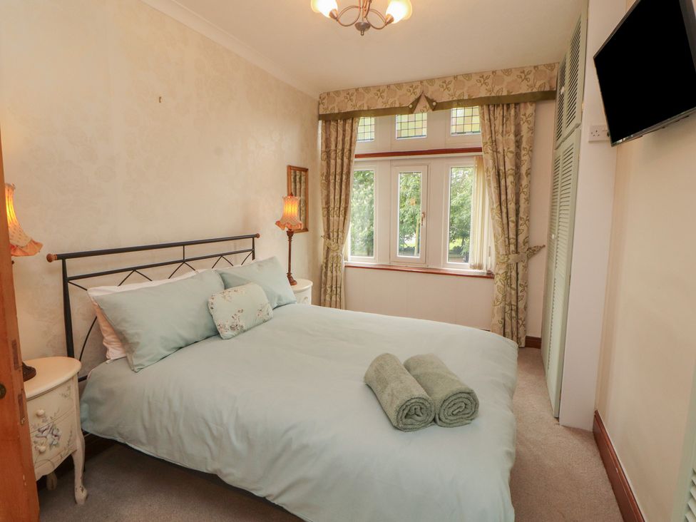 A bedroom with a bed and window at The Haven in Heysham