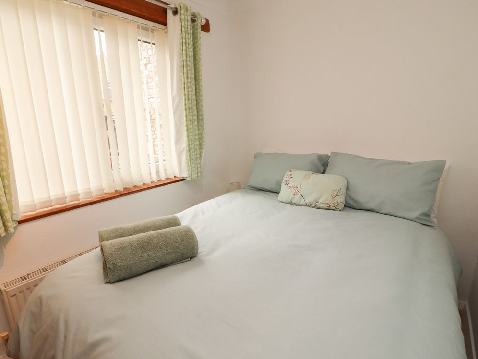 A bedroom with a bed and window at The Haven in Heysham