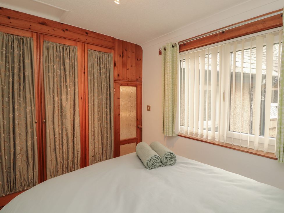 A bedroom with a bed and towels at The Haven in Heysham