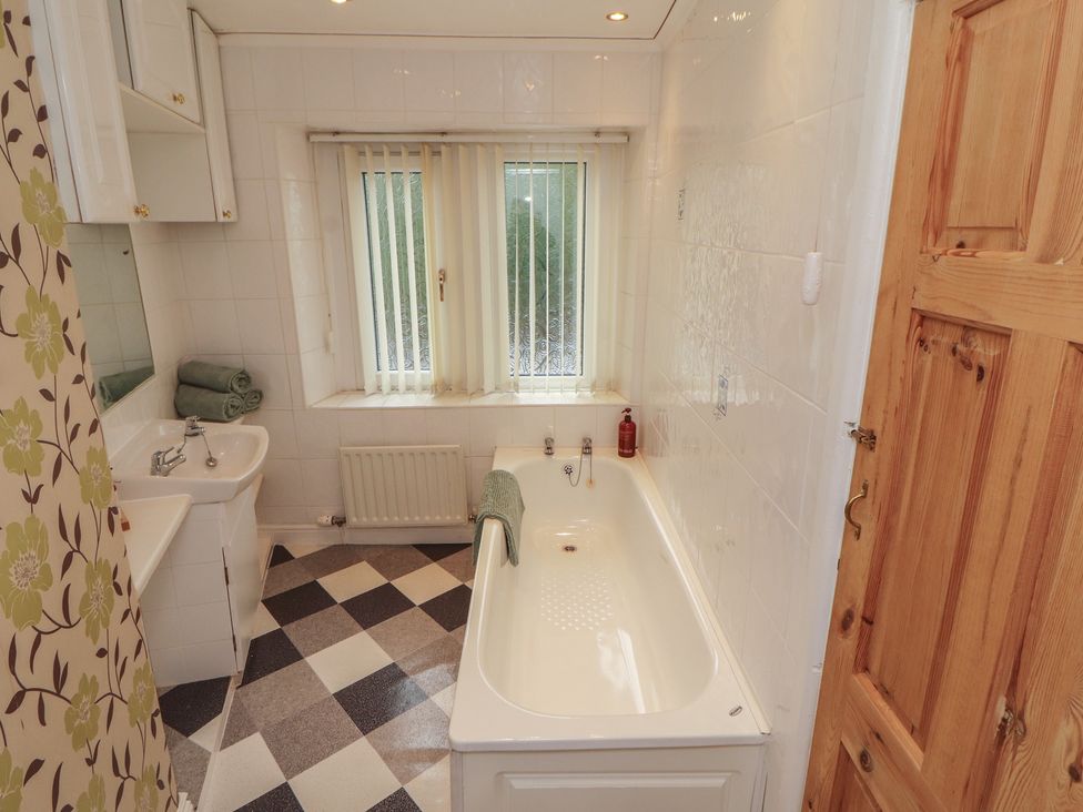 A bathroom with a bathtub and sink at The Haven in Heysham