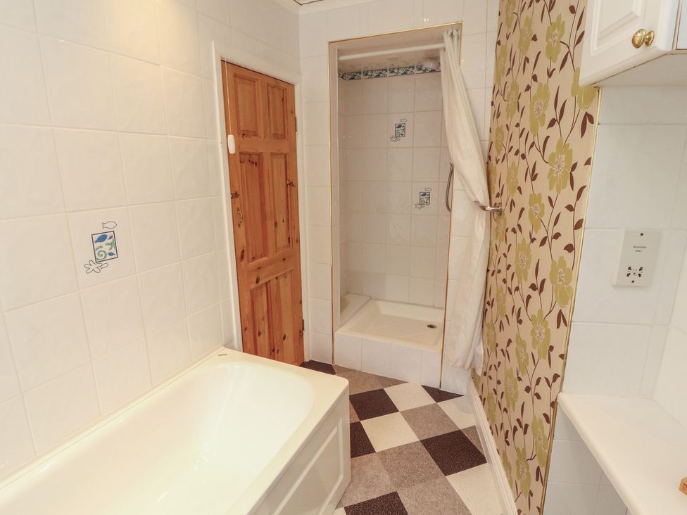 A bathroom with a bathtub and a shower at The Haven in Heysham