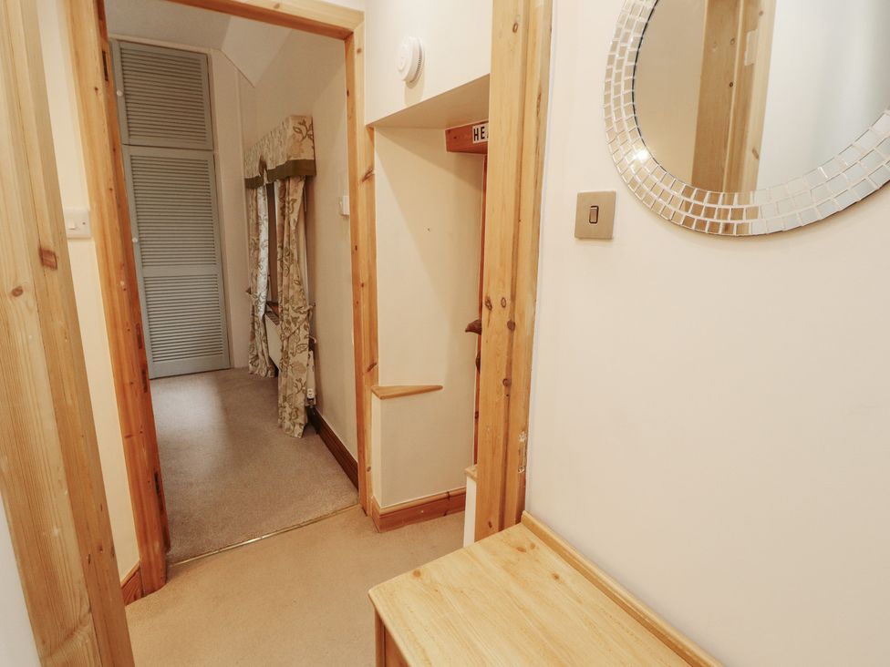 A hallway with a mirror and a table at The Haven in Heysham
