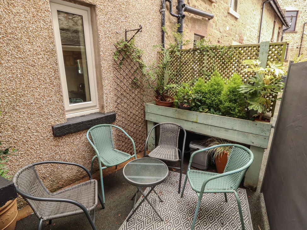 An outdoor area with chairs and a table at The Haven in Heysham