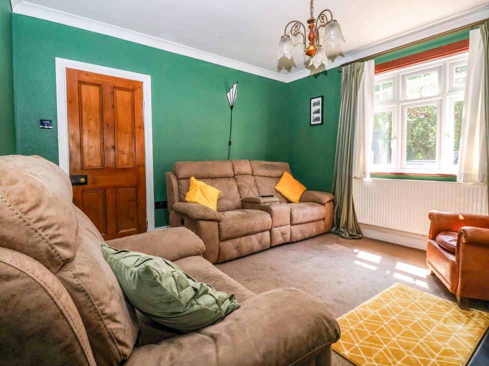 A living room with sofas and an armchair at The Old Post Office