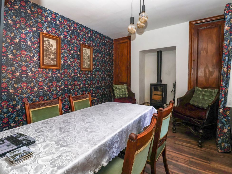 A dining room with a table and chairs at The Old Post Office 
