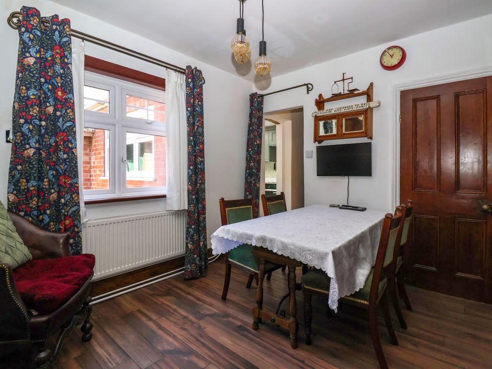 A dining room with a table and chairs at The Old Post Office 