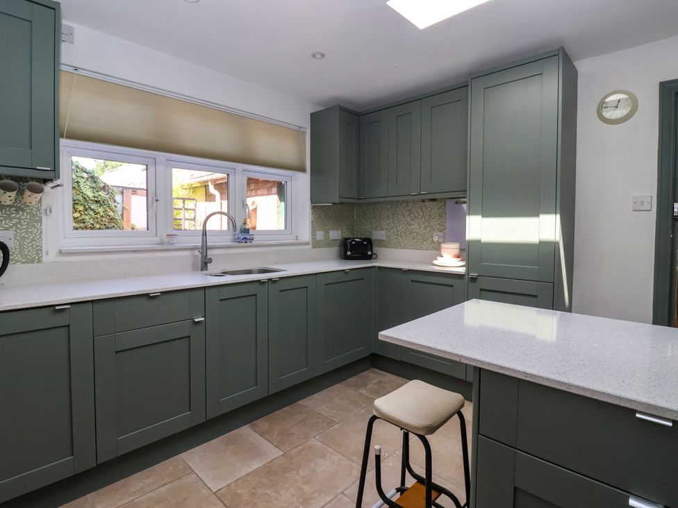 A kitchen with cabinets and a countertop at Old Post Office