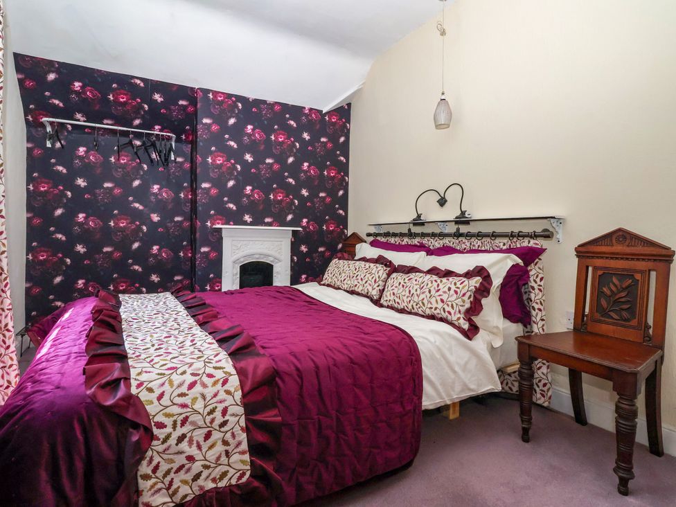 A bedroom with a bed and a bedside table at The Old Post Office