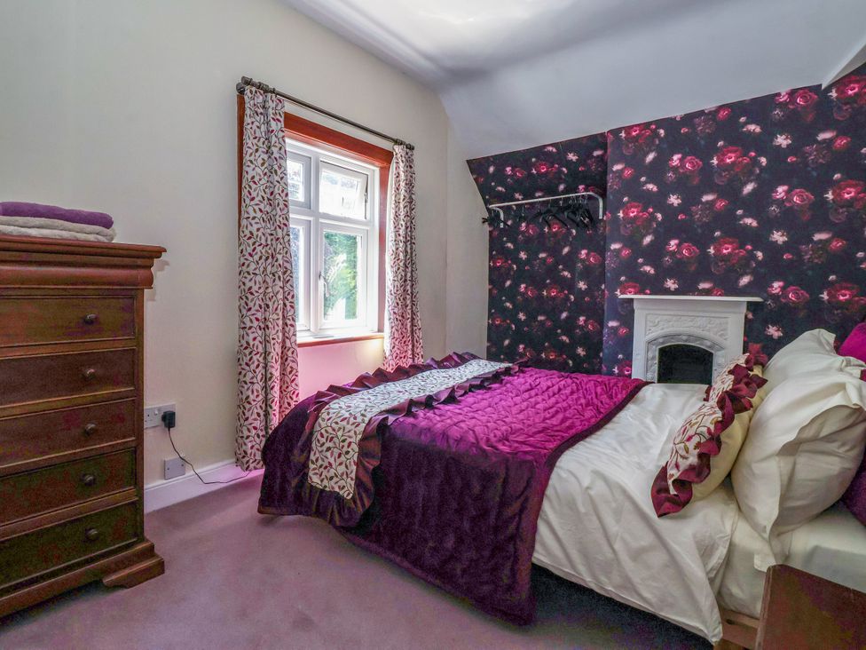 A bedroom with a bed and dresser at The Old Post Office