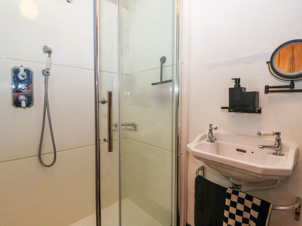 A bathroom with a shower and sink at The Old Post Office