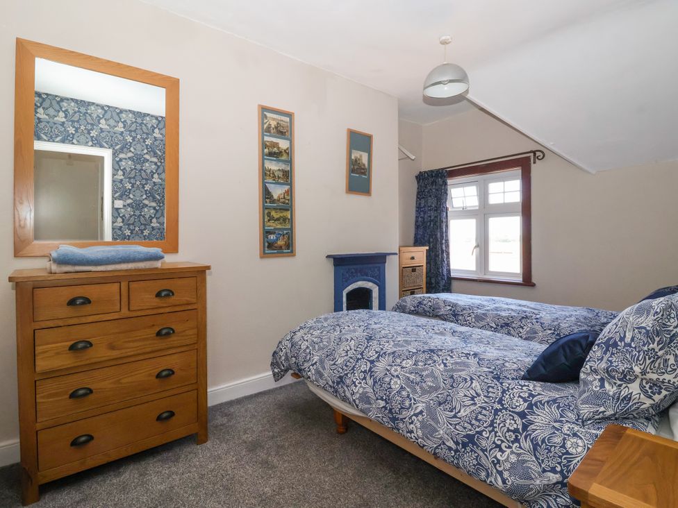 A bedroom with two beds and a dresser at The Old Post Office 
